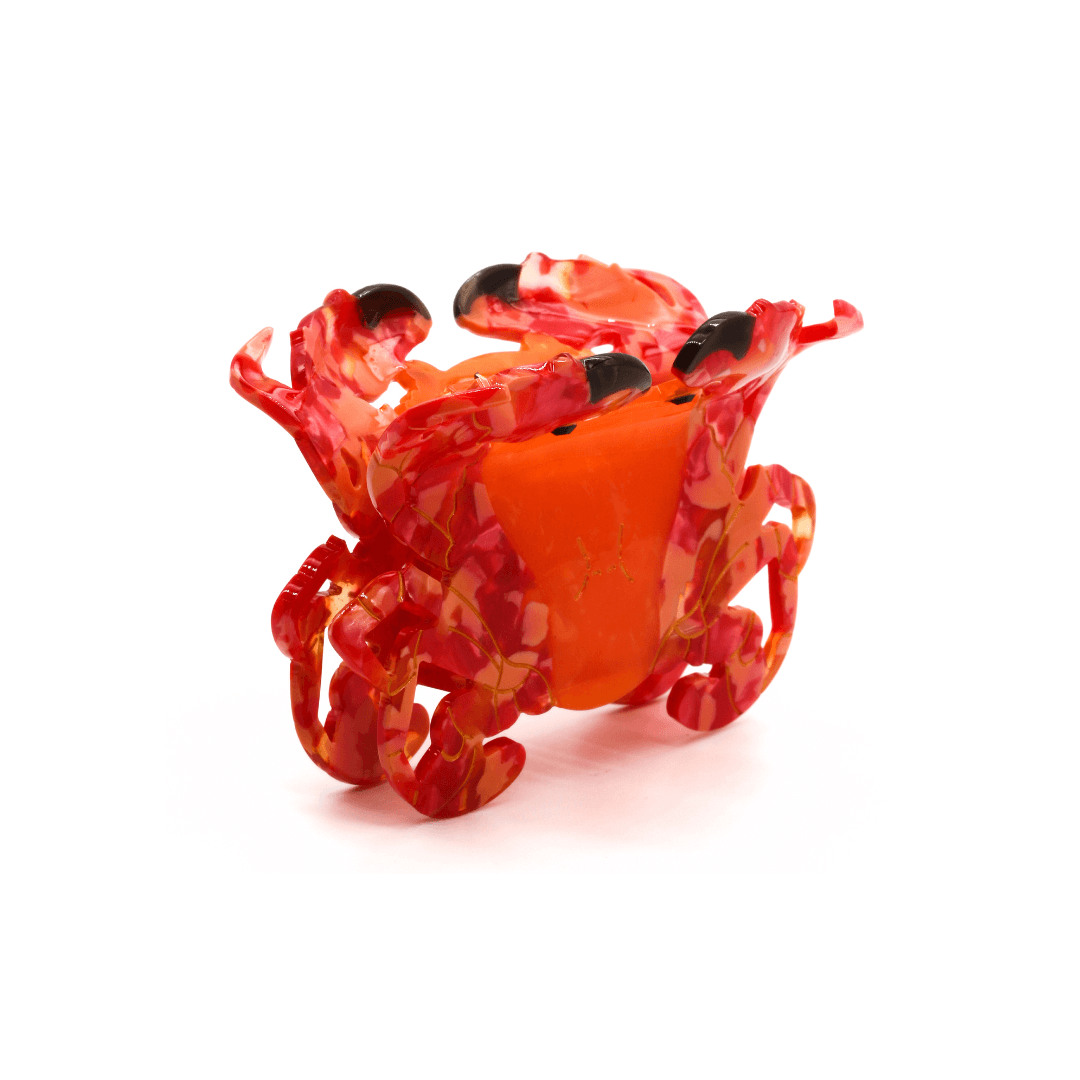 Colorful crab-shaped hair clip for playful seaside-inspired looks, featuring smooth cellulose acetate. CRAB HAIRCLIP.