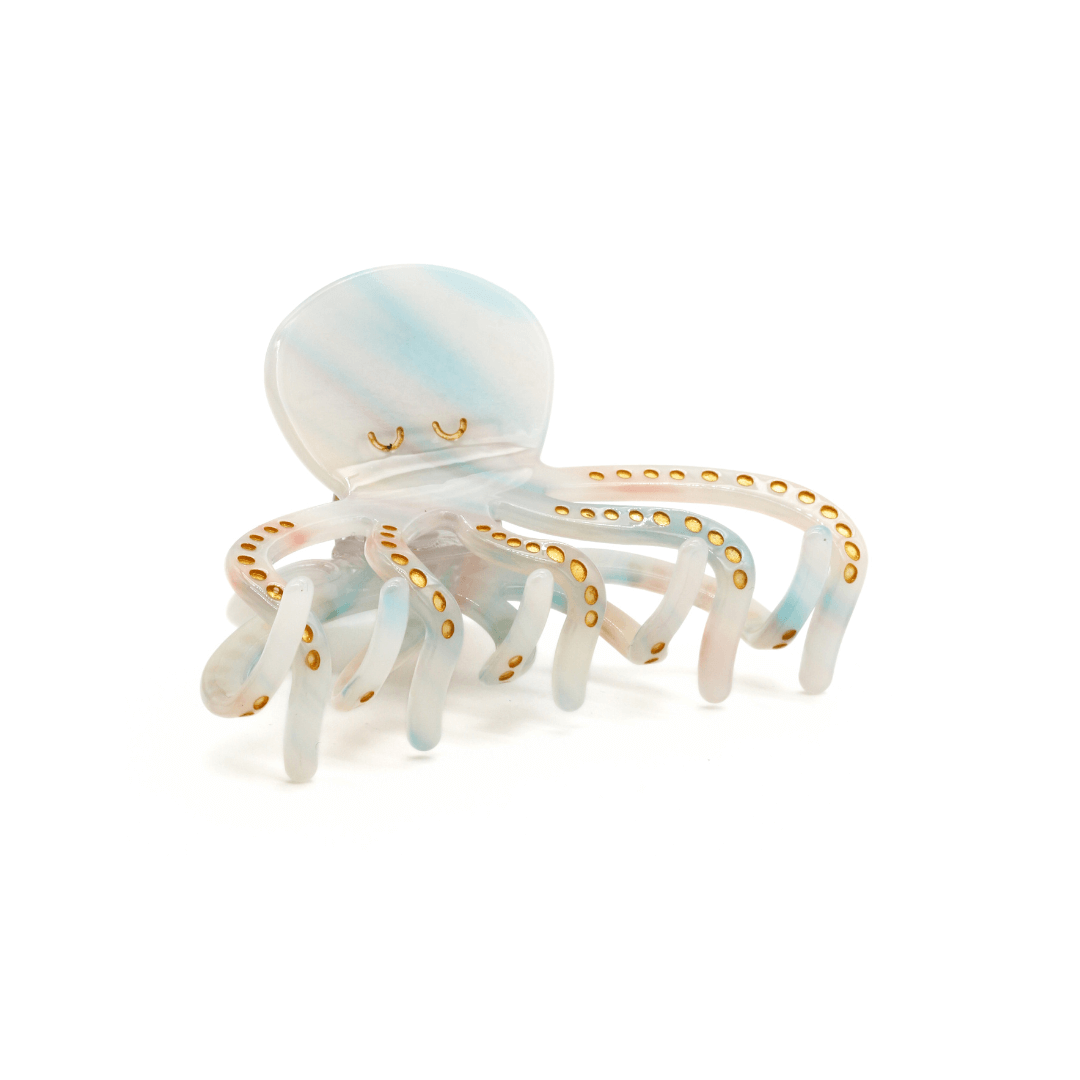 A whimsical JELLYFISH HAIRCLIP designed in blue and white tones, perfect for beach-inspired hairstyles.