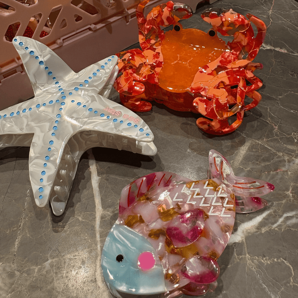 Colorful crab, starfish, and fish-shaped hair clips showcasing vibrant ocean-inspired designs.